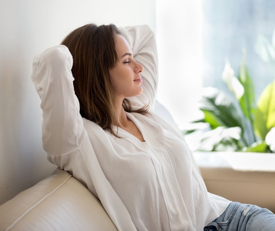 woman relaxing on the sofa practicing mindfulness