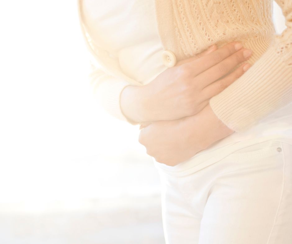 woman holding stomach looking for Natural Treatments for IBS