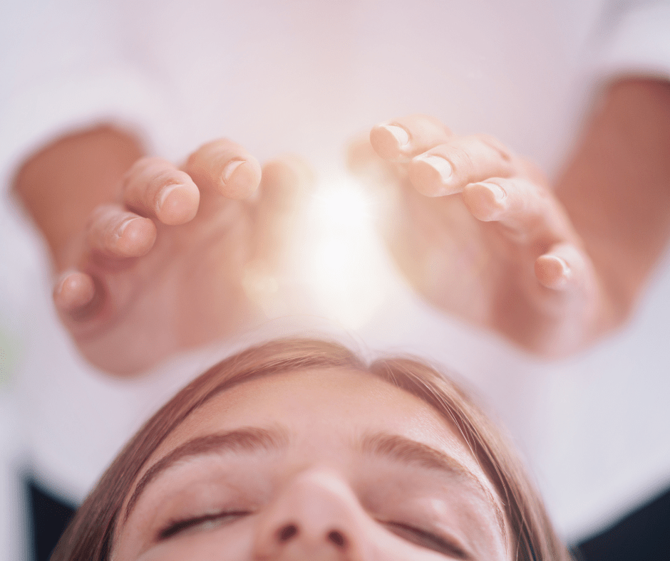 healing hands over women's face